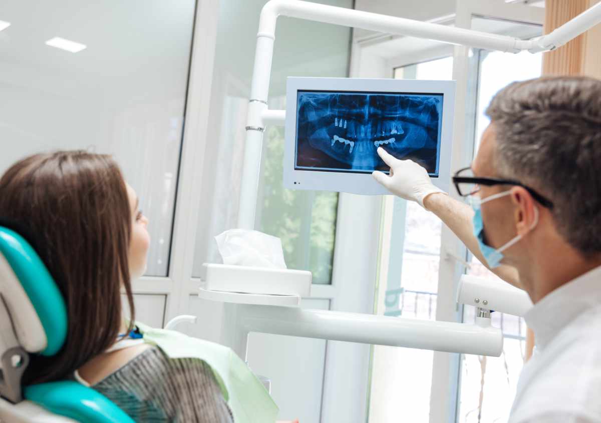 Dentist examining dental x-ray.