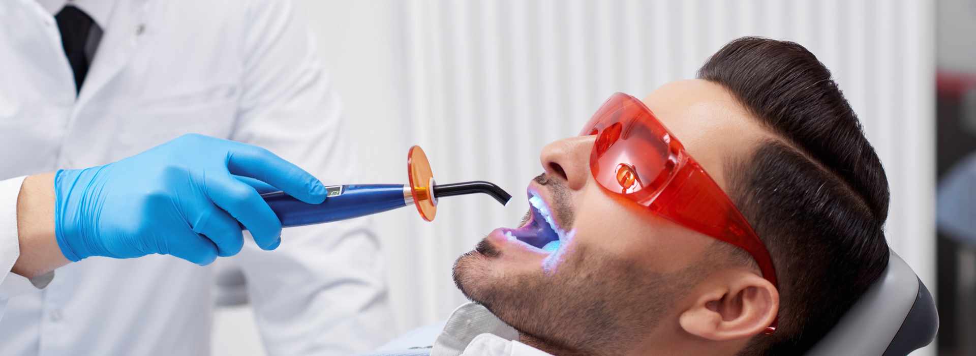 A man is having teeth whitening treatment.
